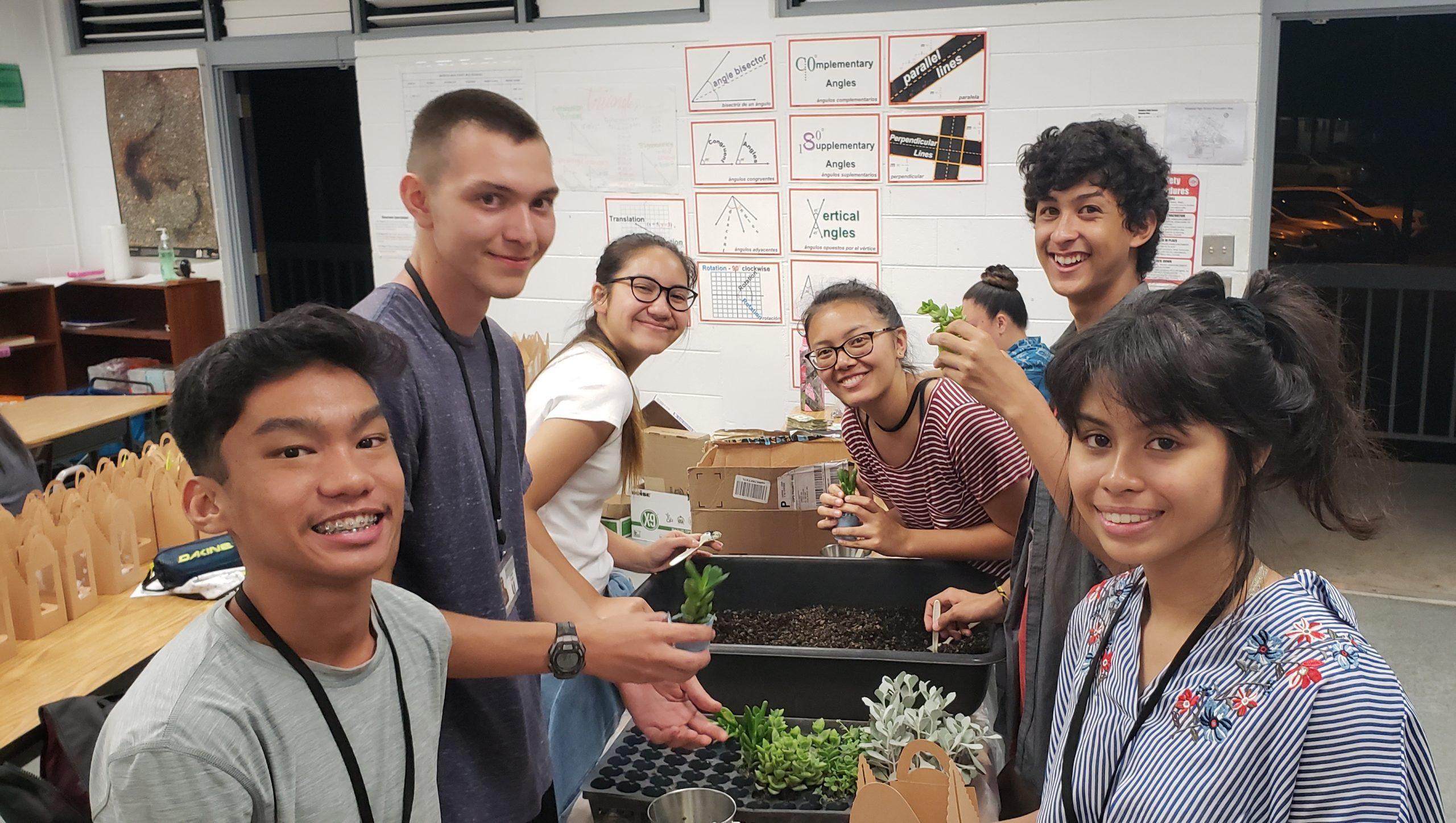 Students from the HFs Sponsored Junior Achievement Company, United Youth, are repotting their succulent plants, one of their company products