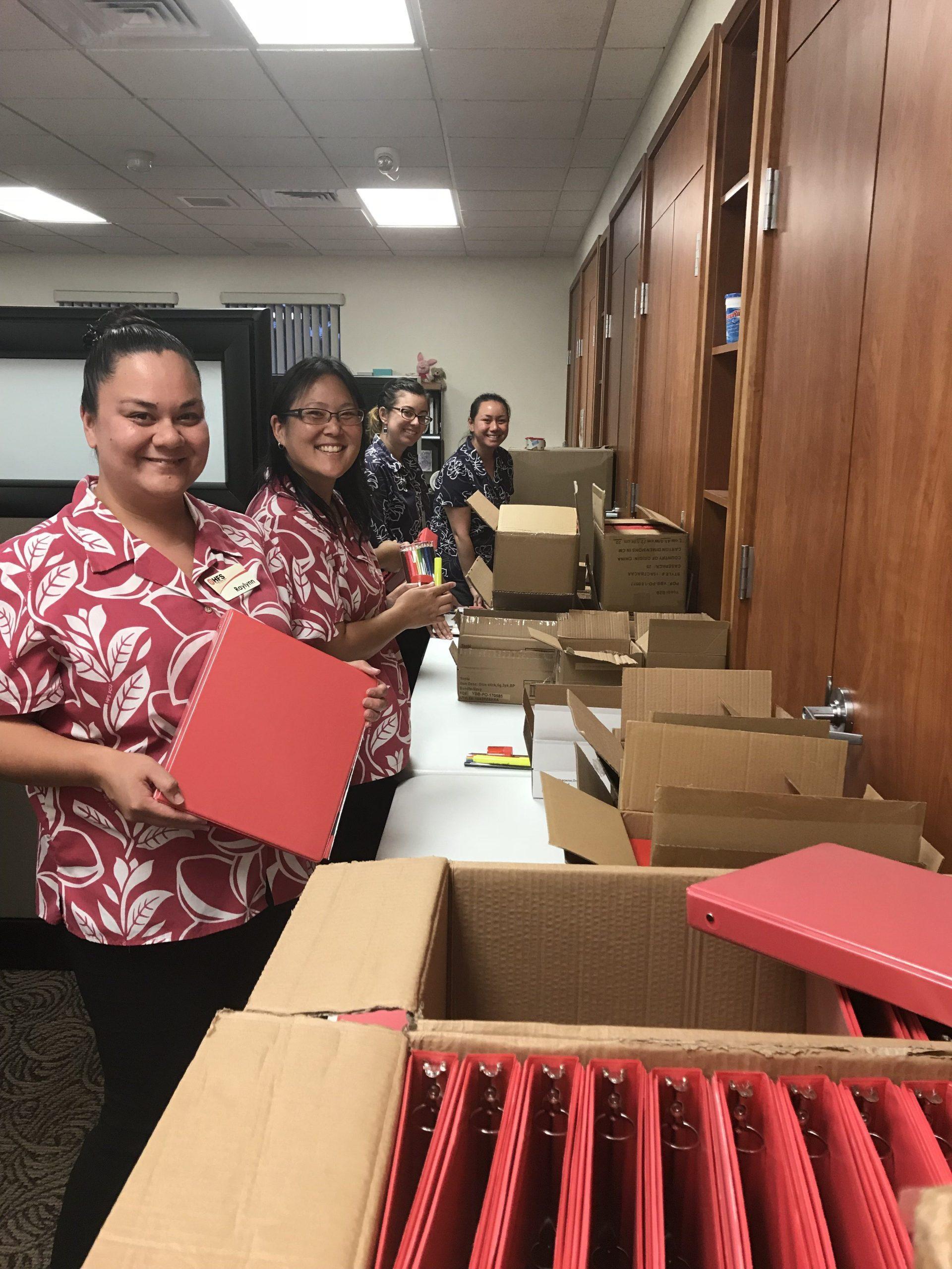 staff pack away school supplies to donate