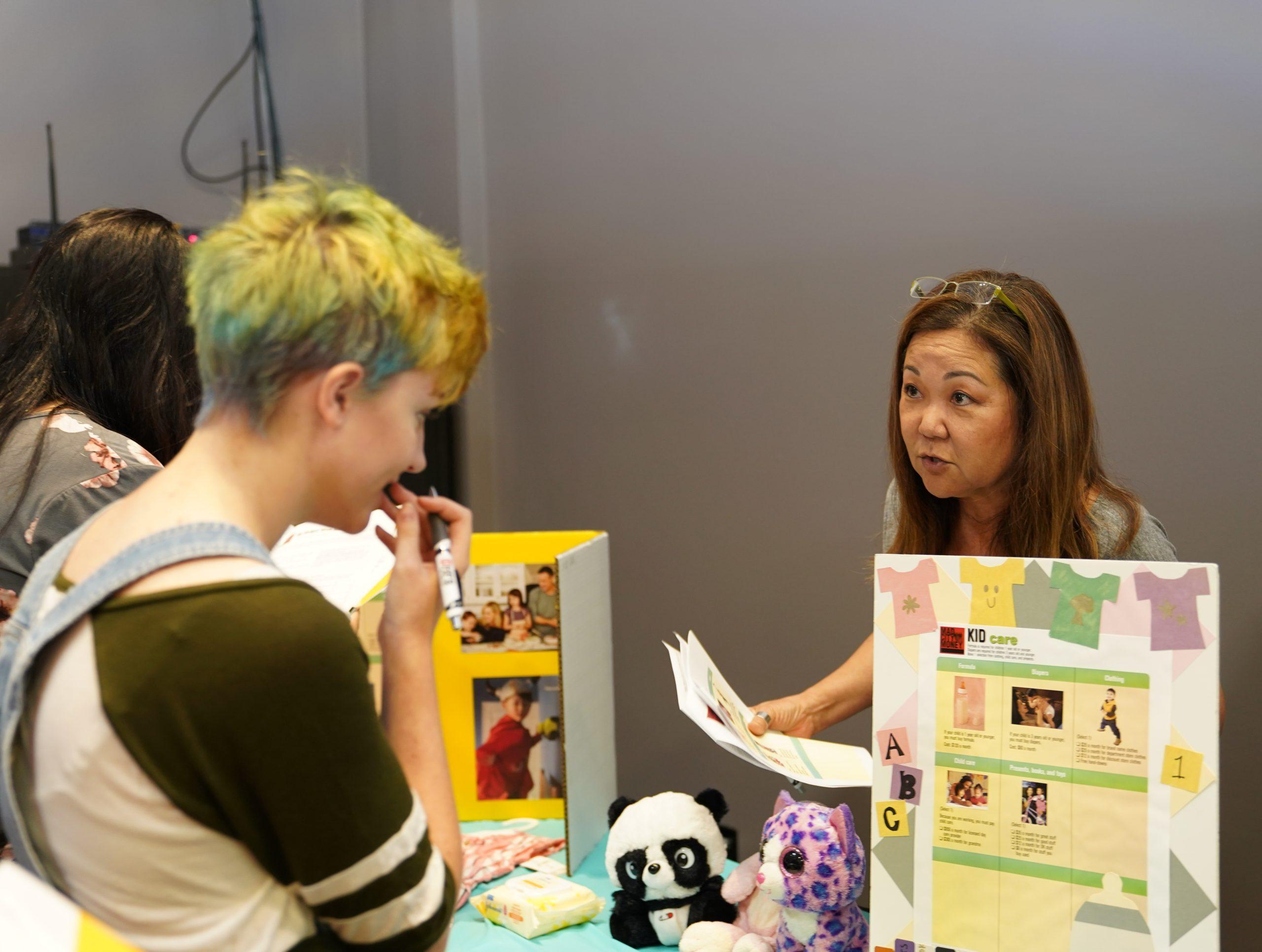 student purchases items at kid care table