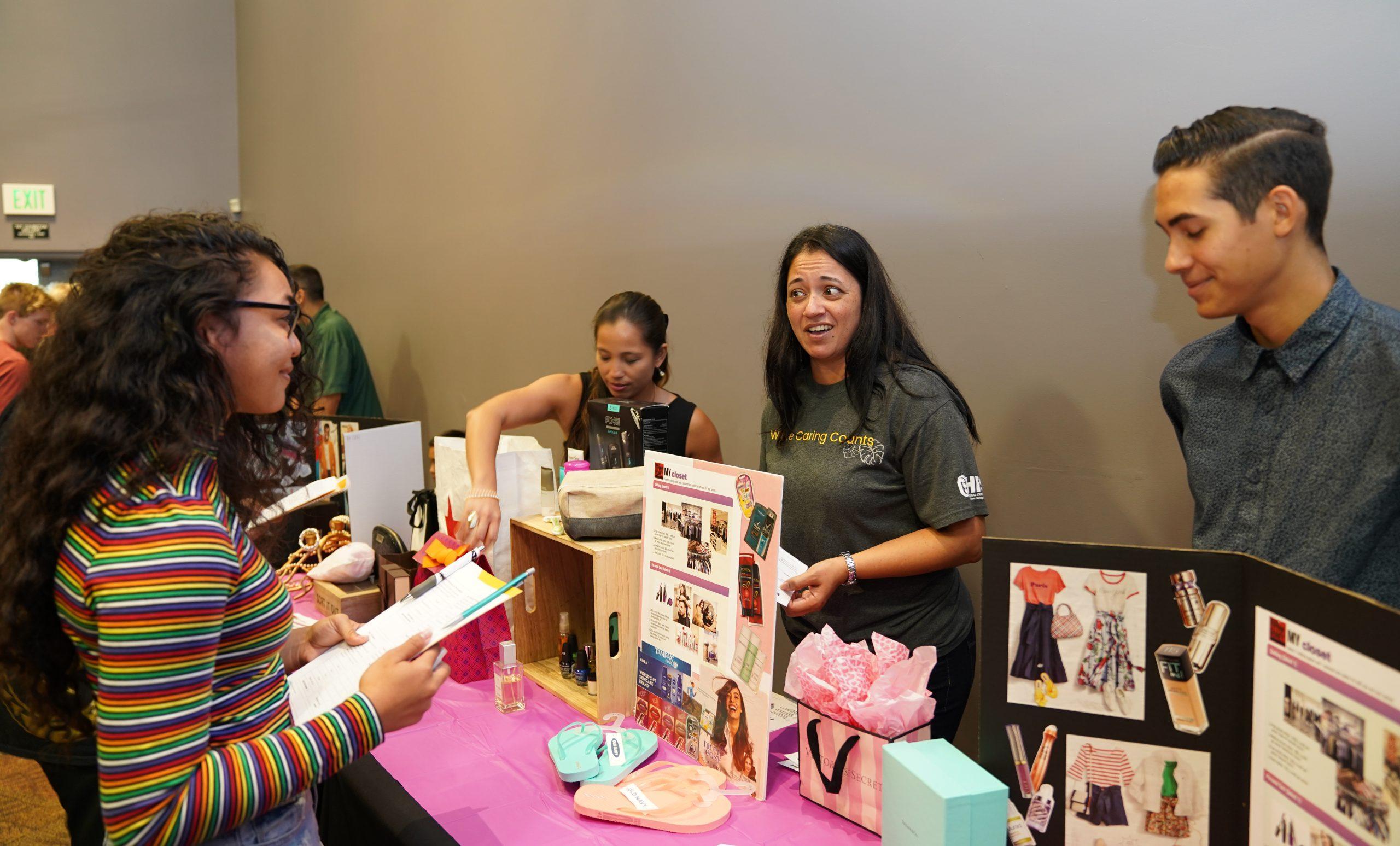 staff up sell at the clothing table