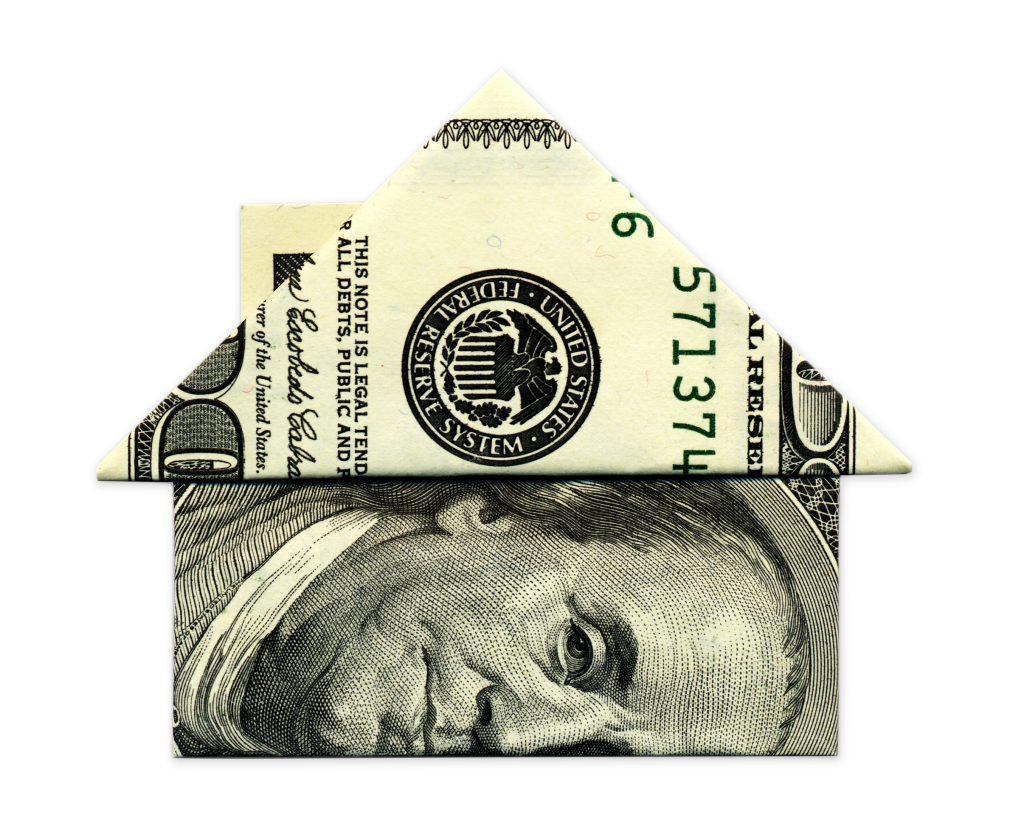 a $100 dollar bill folded into the shape of a house