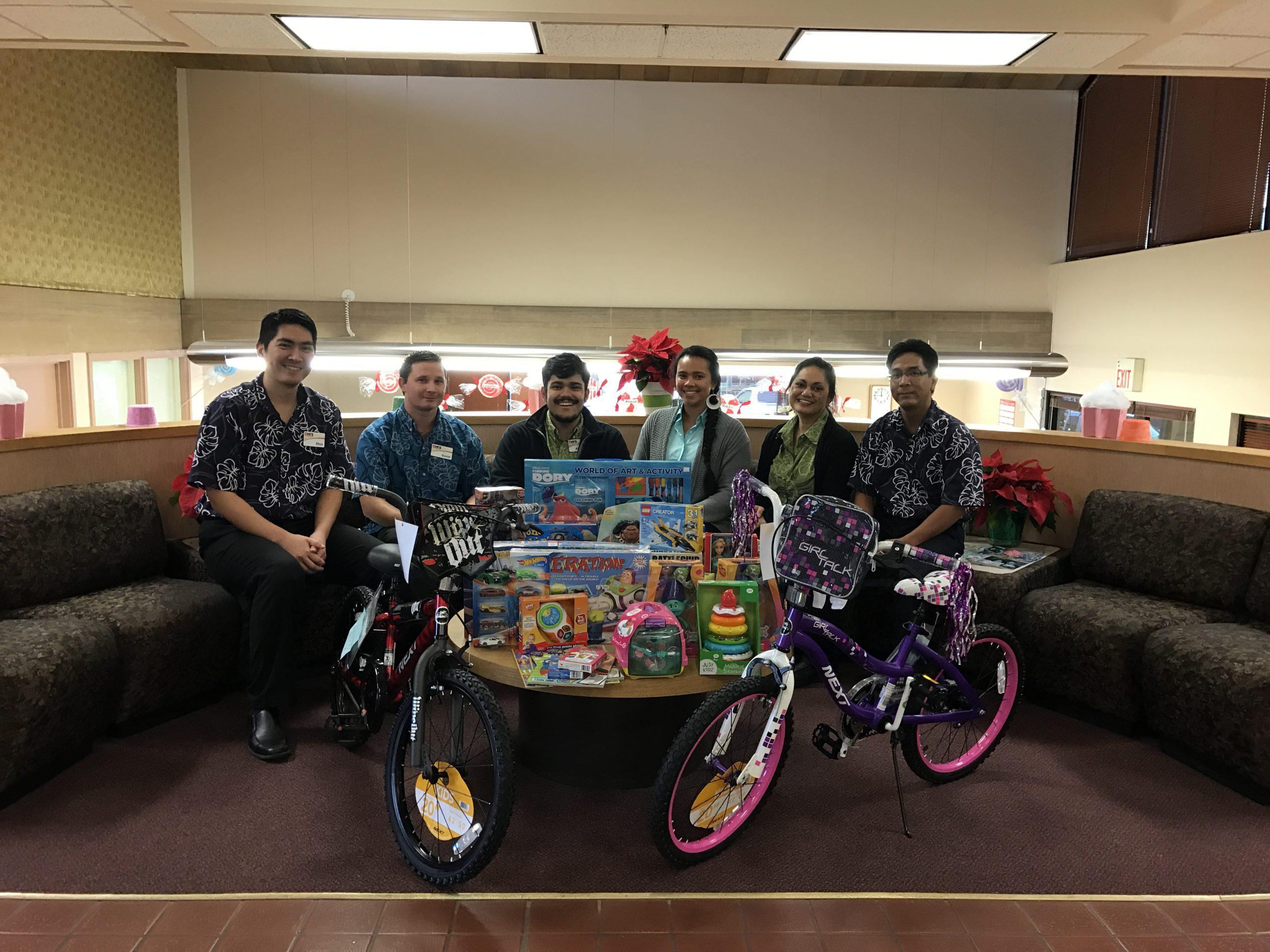 Staff smile with donated toys