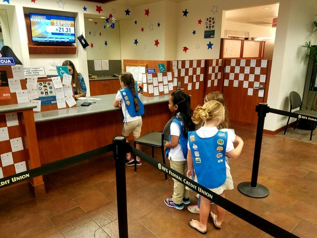 girls making deposits at teller window