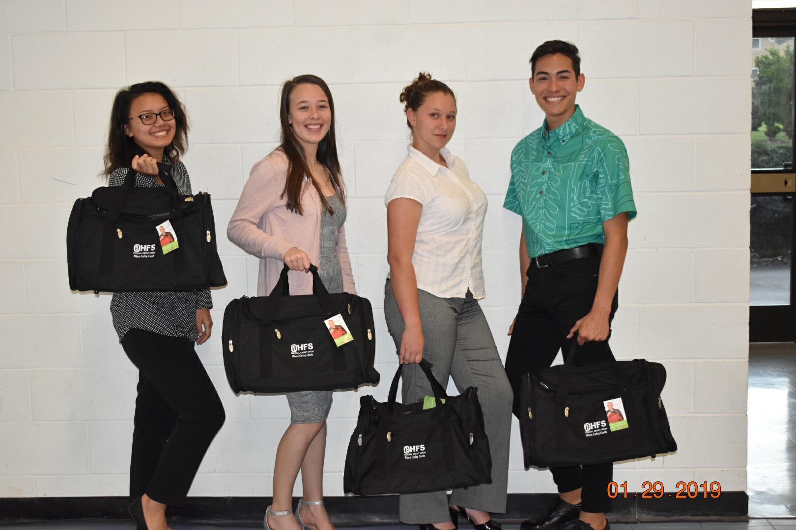 Graduating seniors from United Youth pose with their gifts, HFS duffel bags.